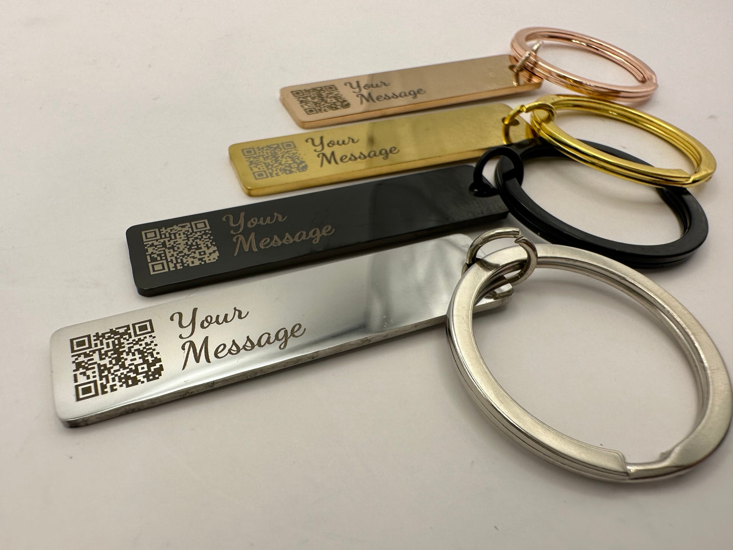 Set of keychains with engraved 'Your Message' text on a light background