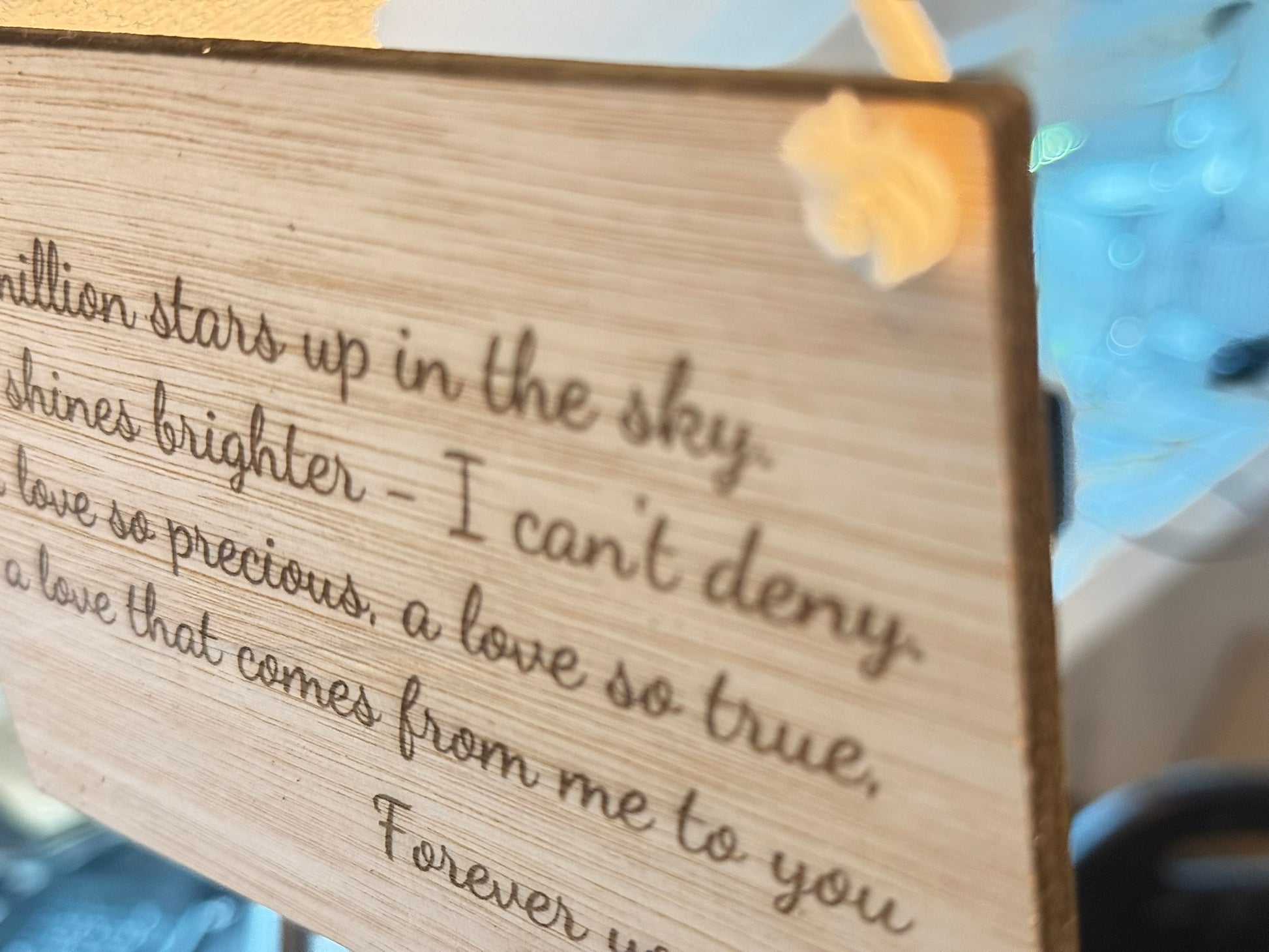 Wooden plaque with engraved text on a blurred background