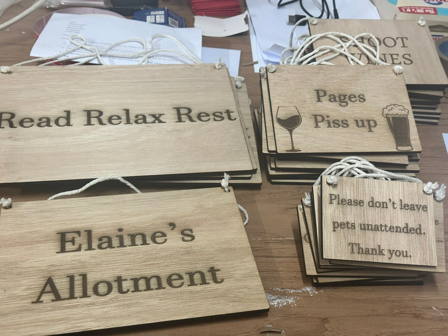 Wooden signs with engraved text on a wooden surface