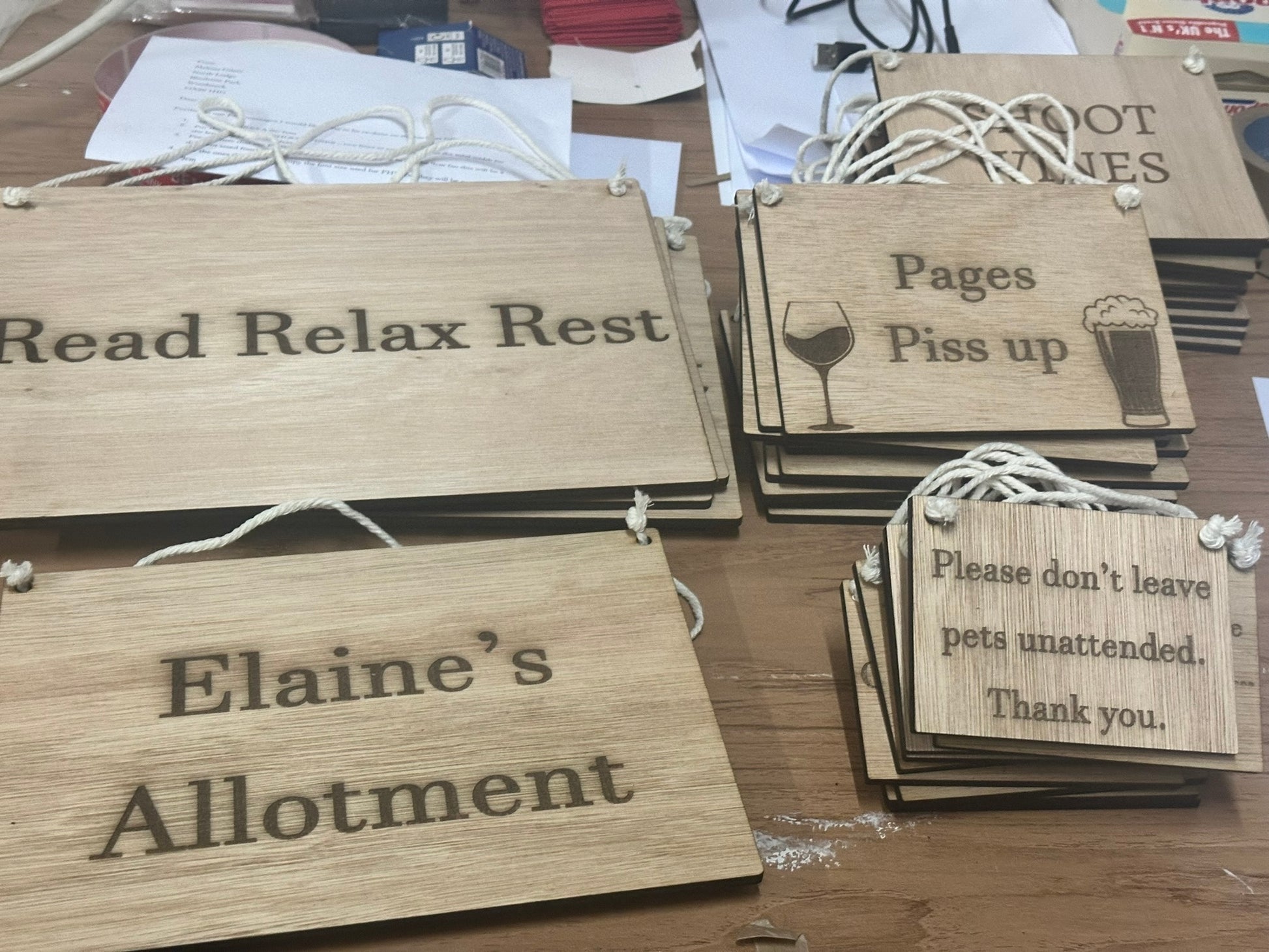 Wooden signs with engraved text on a wooden surface
